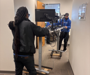 Our team moves computer equipment on a wheeled stand in a hallway